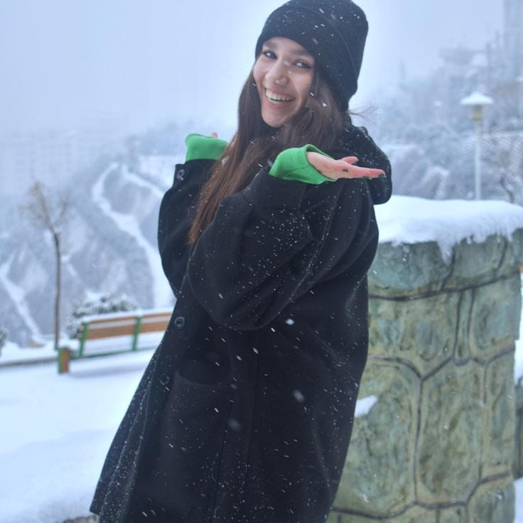 Asha Rao, Lead Design Curator at TimberCloudFlint, reviewing corporate floral arrangements